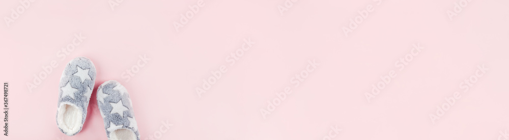Soft fluffy slippers on pink background Soft fluffy slippers on pink background