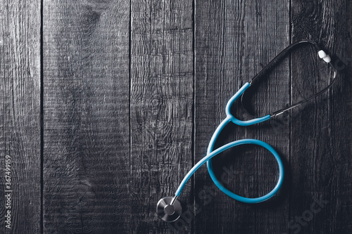 Stethoscope on wooden background. Medicine concept