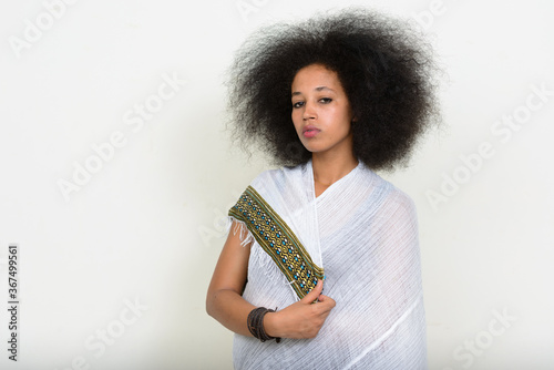 Portrait of young beautiful African woman with Afro hair in traditional clothing