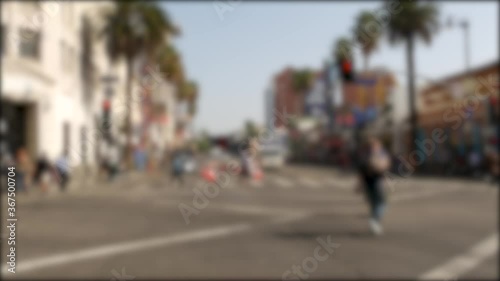 Walk of fame promenade, Los Angeles, Hollywood boulevard, California, USA. Pedastrians walking on on crossroad of streets. Entertainment and cinema industry iconic tourist landmark. Palms in LA city.