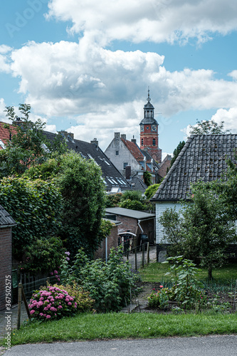 View of Sint Lambertuskerk protestant church in small town Buren, Gelderland, the Netherlands. Sunny summer day with blue sky with clouds. July 2020 photo