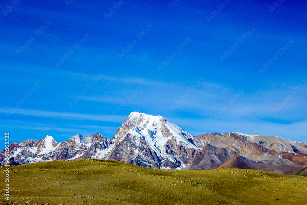 Snowy mountain and holy lake with blue sky