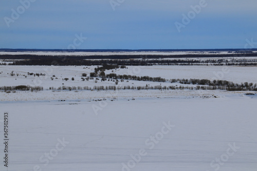Landscapes of the Khanty-Mansiysk Autonomous Okrug - Ugra. Snow, hills and plains, coniferous forest and frozen rivers