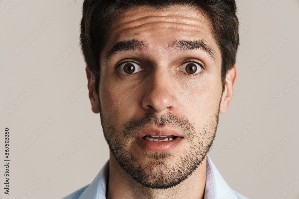 Obraz premium Image of young businesslike brunette man expressing surprise on camera