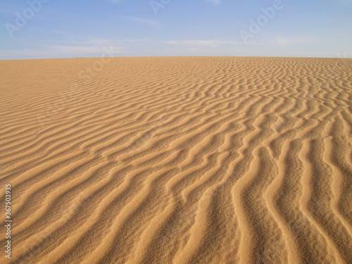 TAMANRASSET, HOGGAR MOUNTAINS. THE SAHARA DESERT IN SOUTHERN ALGERIA. SAND DUNES AND ROCK FORMATIONS.