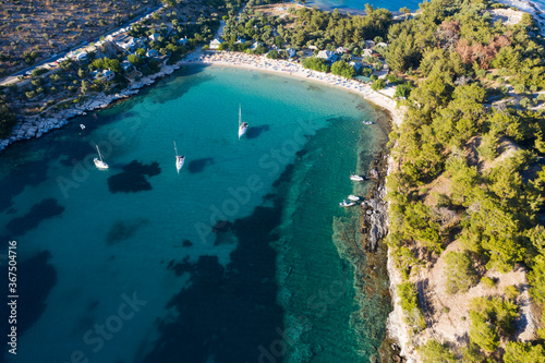 Sail boats in turquoise water in Thassos, Greece