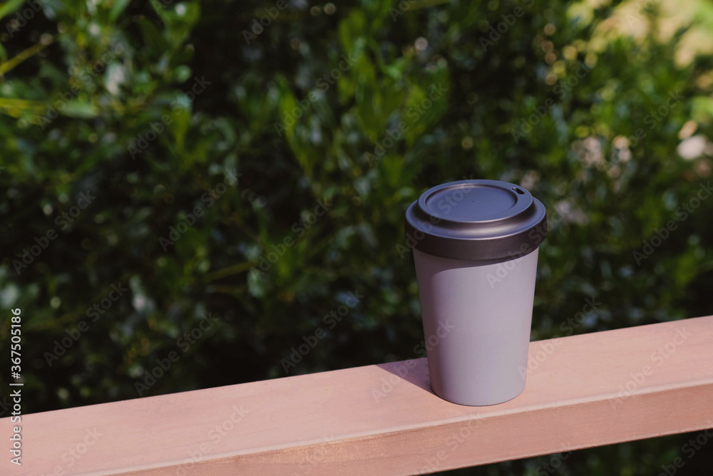 Obraz premium Reusable eco-friendly bamboo cup with lid, copy space.