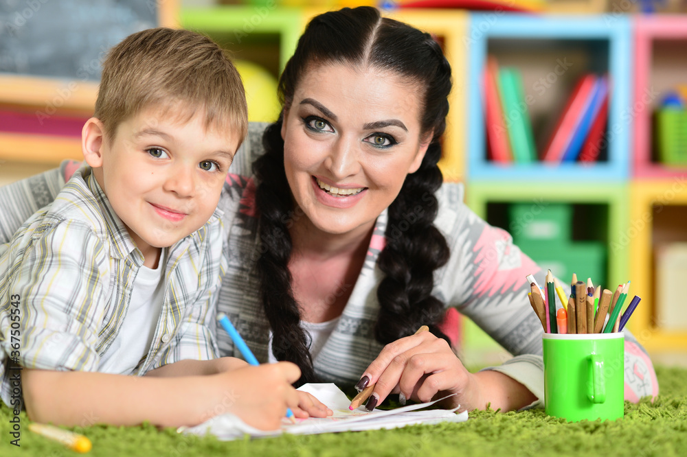 Smiling mother and son drawing with pencils Smiling mother and son drawing with pencils