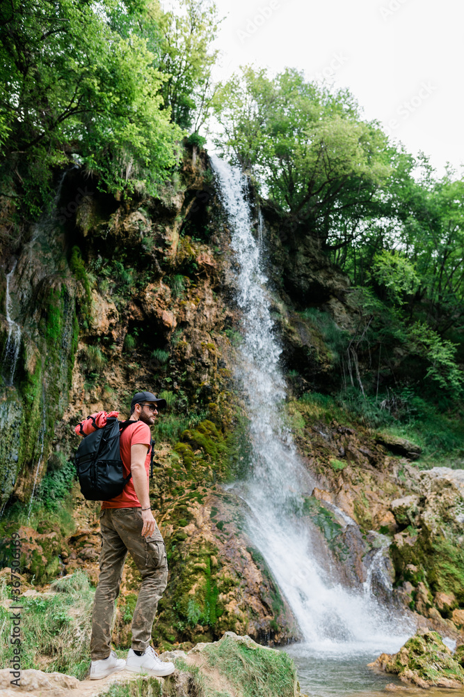 Young male nature explorer by the waterfalls Young male nature explorer by the waterfalls