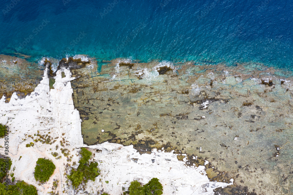 Aerial view of rock formations at beautiful Thassos Islands,Greece from a drone with a turquoise blue ocean during sunrise