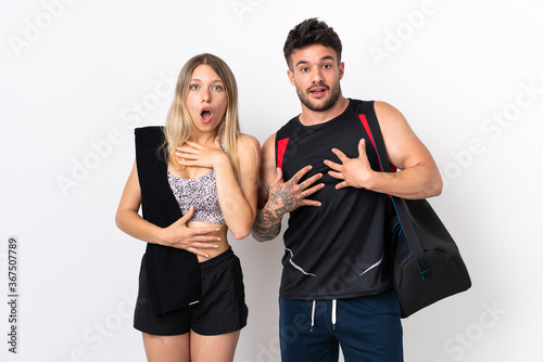 Young sport couple isolated on white background surprised and shocked while looking right
