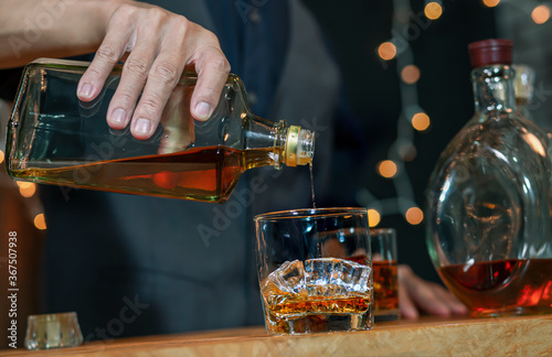Bartender Serve Whiskey on wood bar