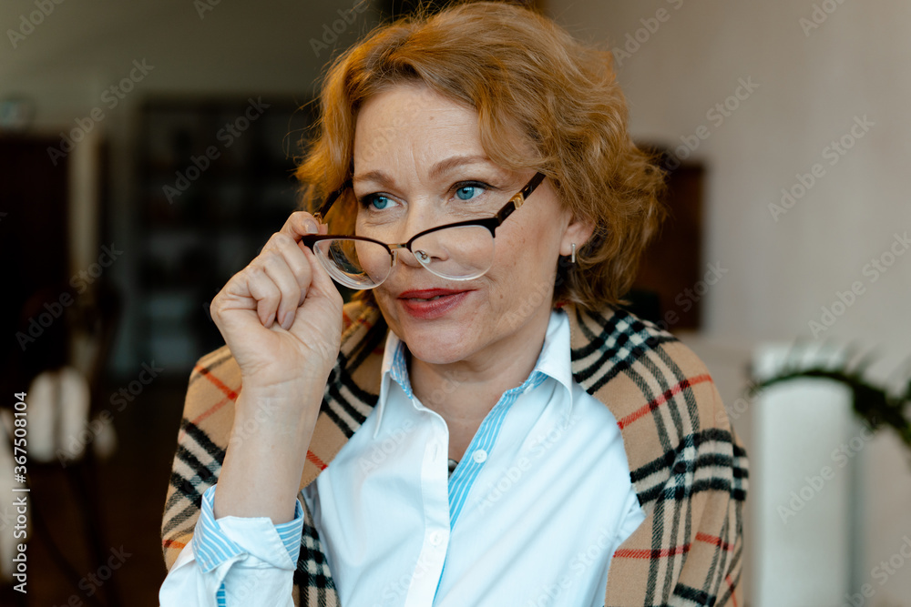 Pensive Senior Woman Taling Off Her Glasses After Reading A Book And Thinking About Its Content. Natural Ageing
