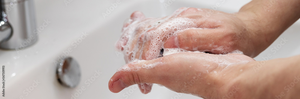 Fototapeta premium Man washing his Hands to prevent virus infection and clean dirty hands