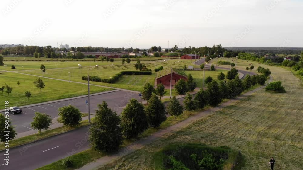 The camera follows the car along the road along the round ice arena in the rays of the setting sun and ancient buildings. Aerial view The camera follows the car along the road along the round ice arena in the rays of the setting sun and ancient buildings. Aerial view