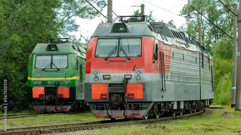 two electric trains standing on the railway tracks in the depot two electric trains standing on the railway tracks in the depot