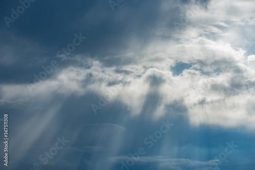 Sun rays break through the stormy clouds. © serjiob74