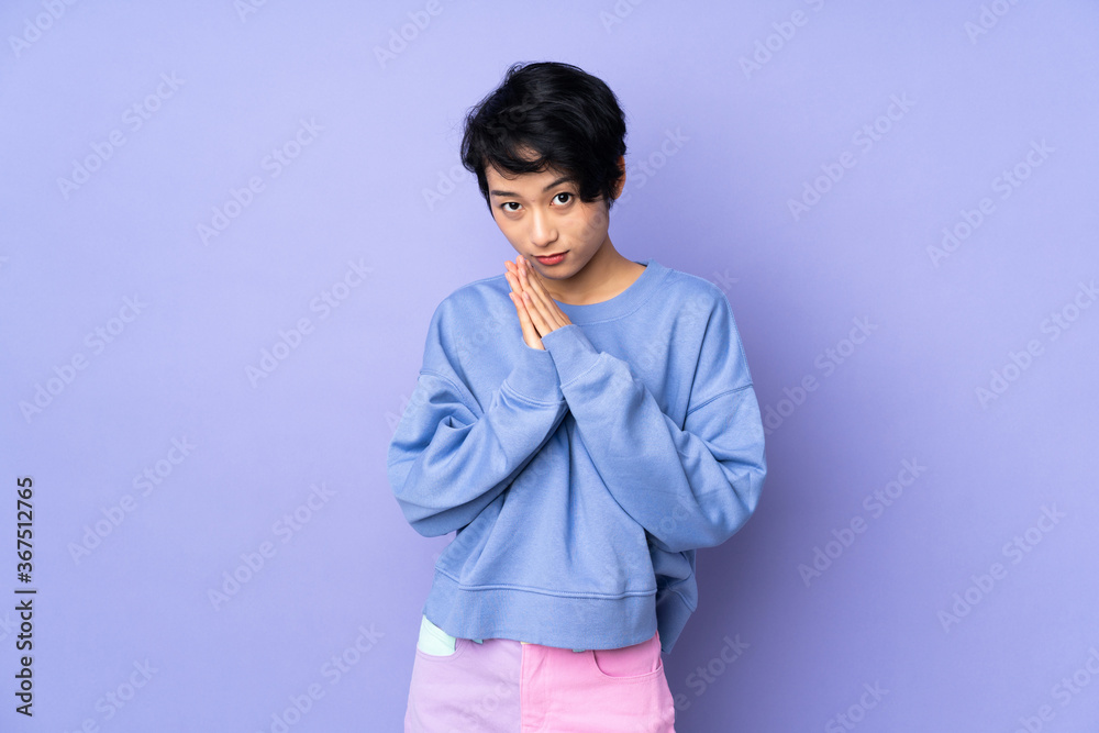 Young asian woman isolated on blue background
Young asian woman isolated on blue background