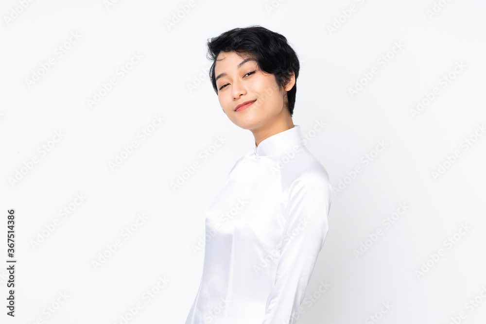 Young Vietnamese woman with short hair wearing a traditional dress over isolated white background . Portrait Young Vietnamese woman with short hair wearing a traditional dress over isolated white background . Portrait