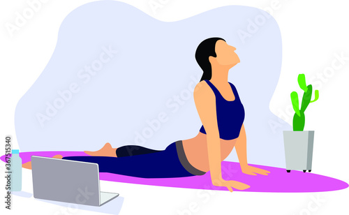 a woman doing yoga exercise while quarantine at home by watching the video tutorial. basic yoga / fitness / gym movements