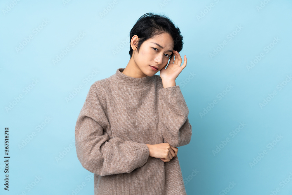 Young Vietnamese woman with short hair over isolated background with headache Young Vietnamese woman with short hair over isolated background with headache