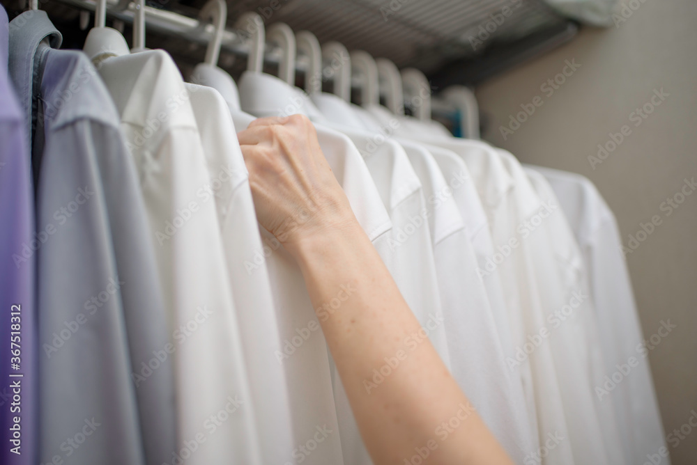 white men's shirts hang on the shoulders in the closet white men's shirts hang on the shoulders in the closet