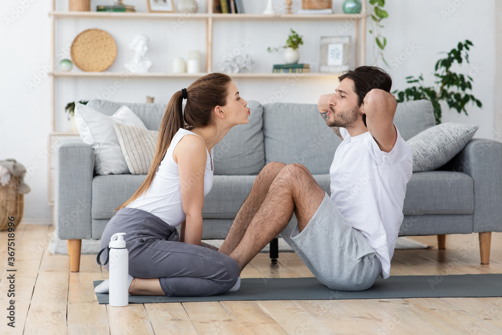 Active young couple exercising together at home Active young couple exercising together at home
