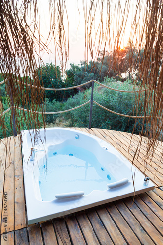 Hot tub in the room balcony with sea view. Luxury honeymoon romantic vacation place.