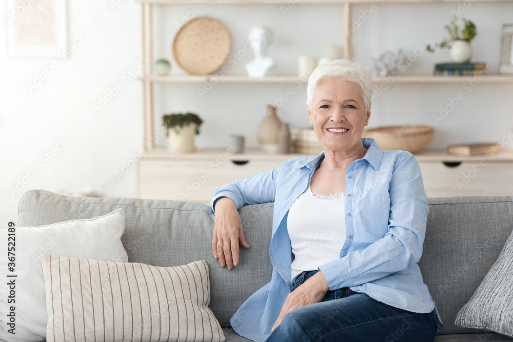 Relaxed Elderly Woman Posing On Couch Im Cozy Home Interior Relaxed Elderly Woman Posing On Couch Im Cozy Home Interior