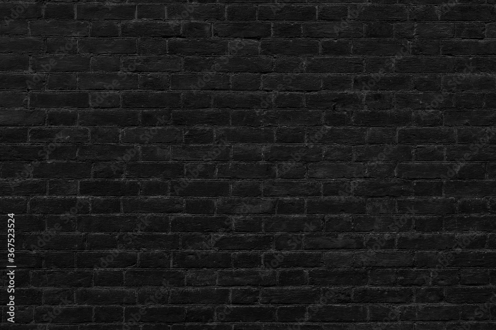 Black brick wall. Loft interior design. Black paint of the facade.