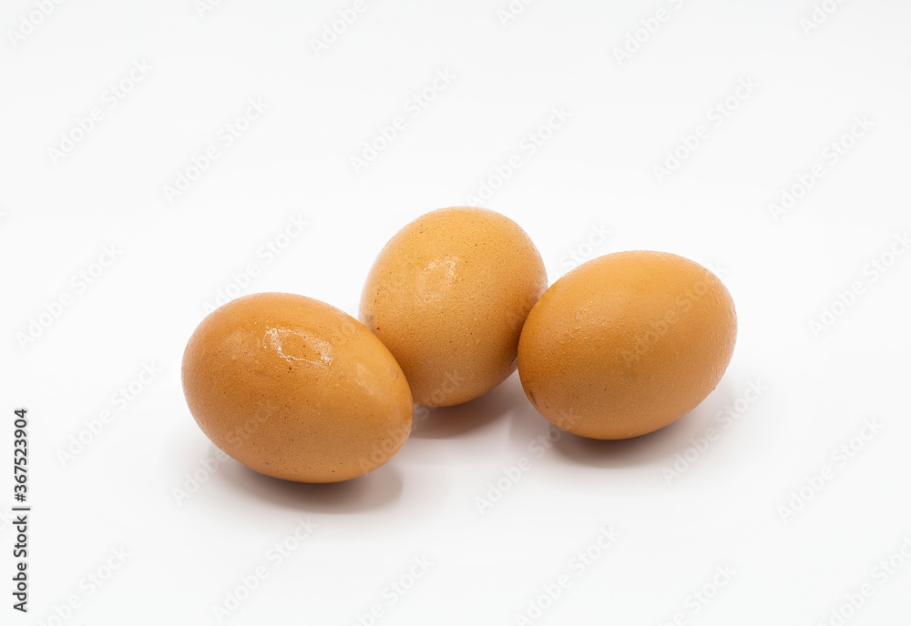 Three brown chicken's eggs isolated on white background. Three brown chicken's eggs isolated on white background.