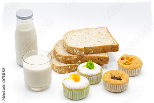 Milk , bread and small cake for snack time, isolated on white background.