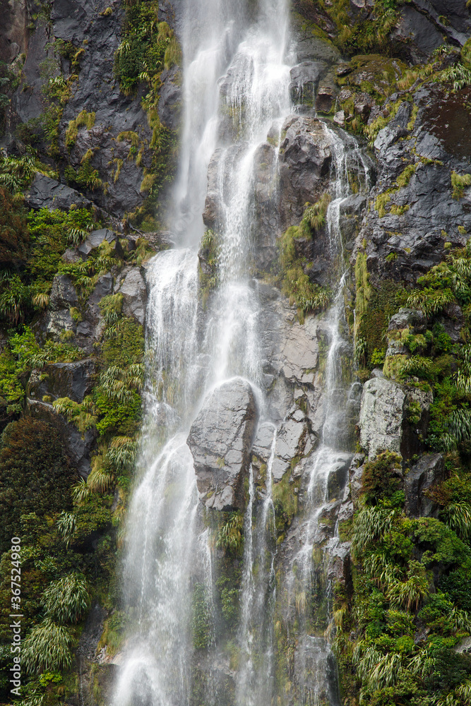 Water falls on Milford Sound - New Zealand. Fiordland National Park.
