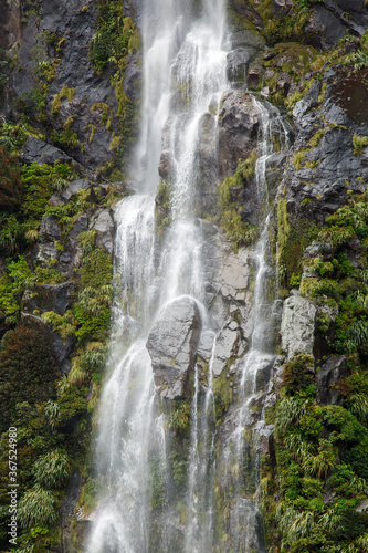 Water falls on Milford Sound - New Zealand. Fiordland National Park.