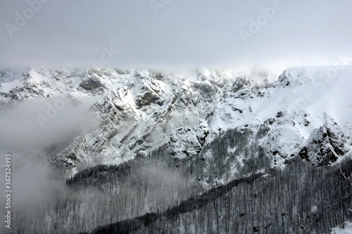 Rocks near Peak Botev, the highest peak of the Balkan Mountains and morning fog photo