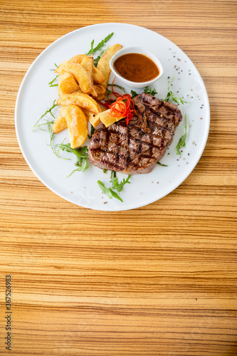 Beautiful steak with fries and bbq sauce