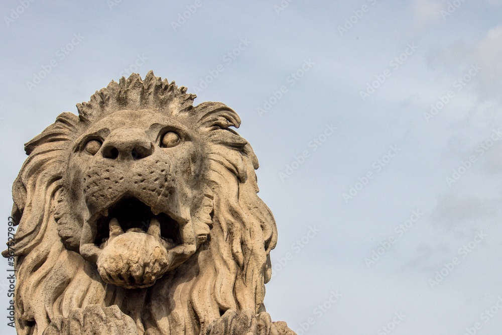 Stone lion statue on sky background Stone lion statue on sky background