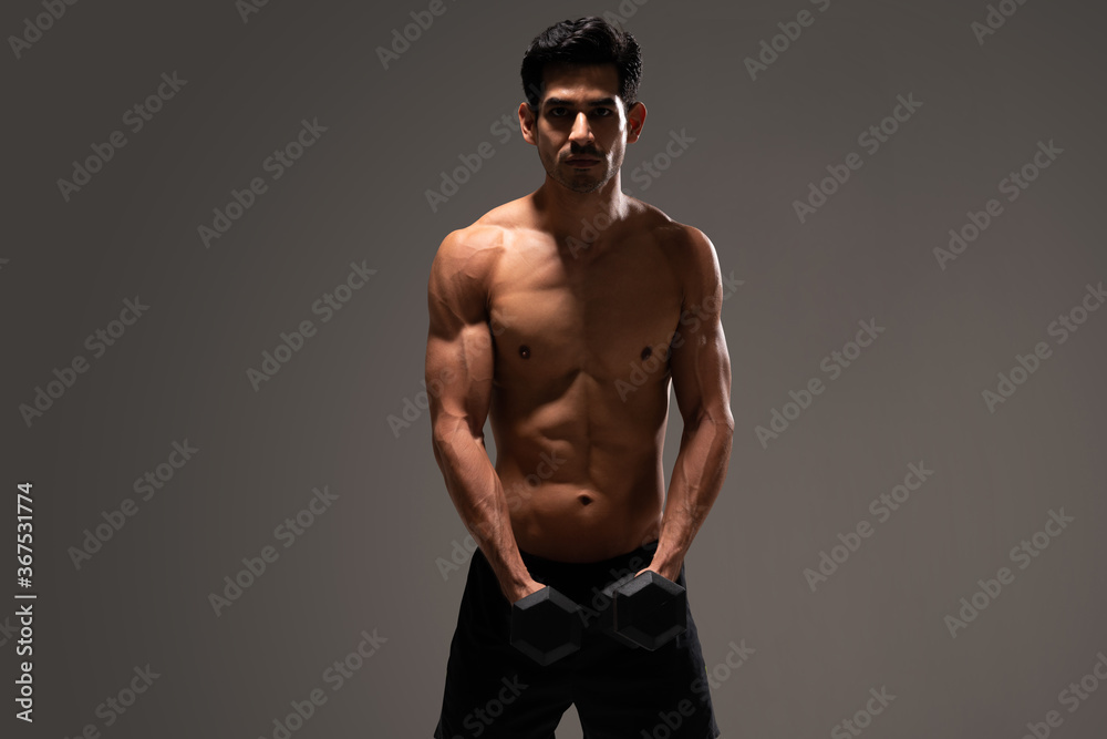 Fototapeta premium Confident Hispanic Man Exercising At Studio