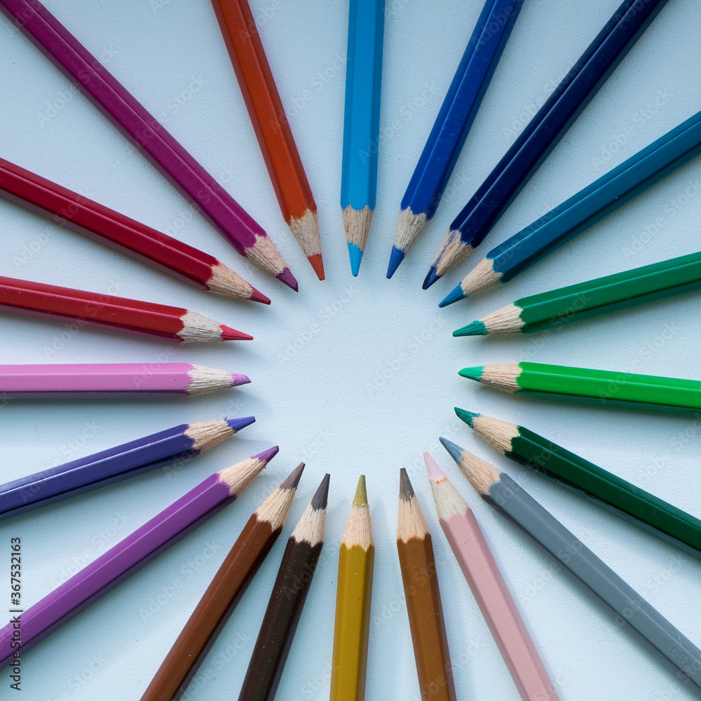 Сolored pencils laid out in a multicolored circle. Preparation for school, buying pencils. Image wit selective focus.