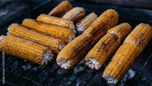 Corn fried on the fire. Hot sweet corn grill. An ear of corn. Healthy food for vegans.