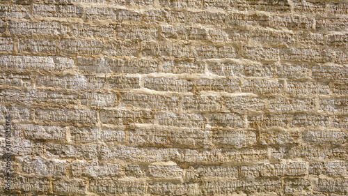 stone wall of roughly cut limestone blocks of different sizes as a background