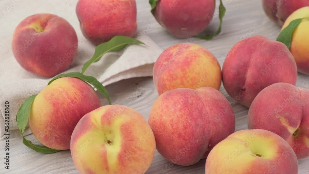 Ripe peach fruits rotate on a wooden background Ripe peach fruits rotate on a wooden background