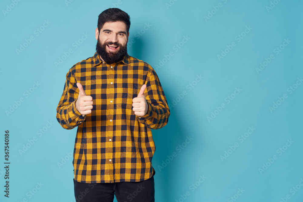  man shows his thumb and laughs at the camera a free space