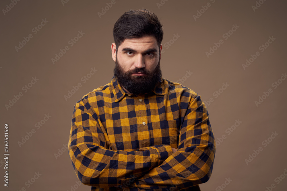 Offended man with beard in plaid shirt on isolated background