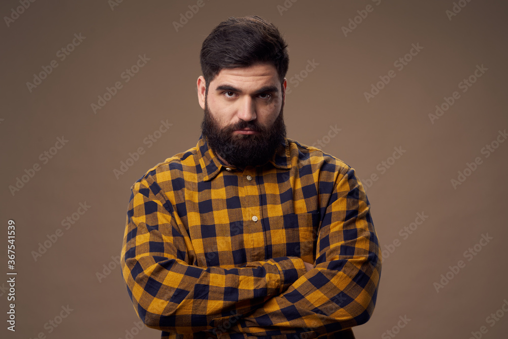 Offended man with beard in plaid shirt on isolated background Offended man with beard in plaid shirt on isolated background