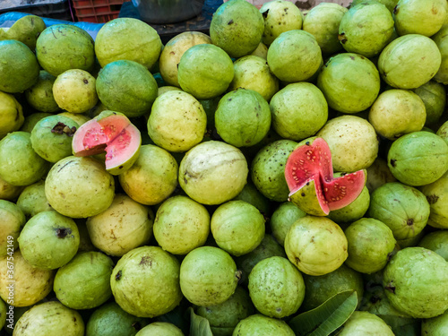Green juicy guavas for sale in an Indian market photo