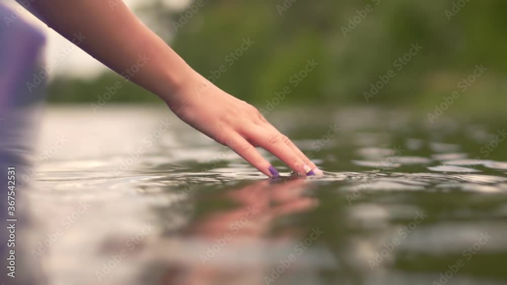 Hands Playing And Touching Water In Slow Motion.Dragging And Sliding Man Hand Through Water Surface.Close Up Woman Hand Splashing Water Enjoying Touching Waves Sliding With Fingers On Pond Surface.