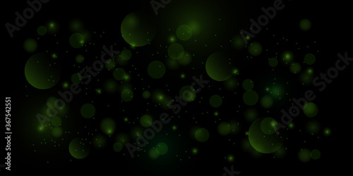 Bokeh style of abstract circles with blur glow spark light on dark green background