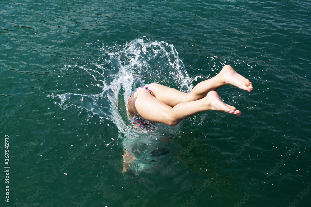 girl jumping into the sea