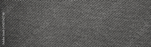 The texture of dark gray fabric is fluted in stripes.Background of dense gray fabric.